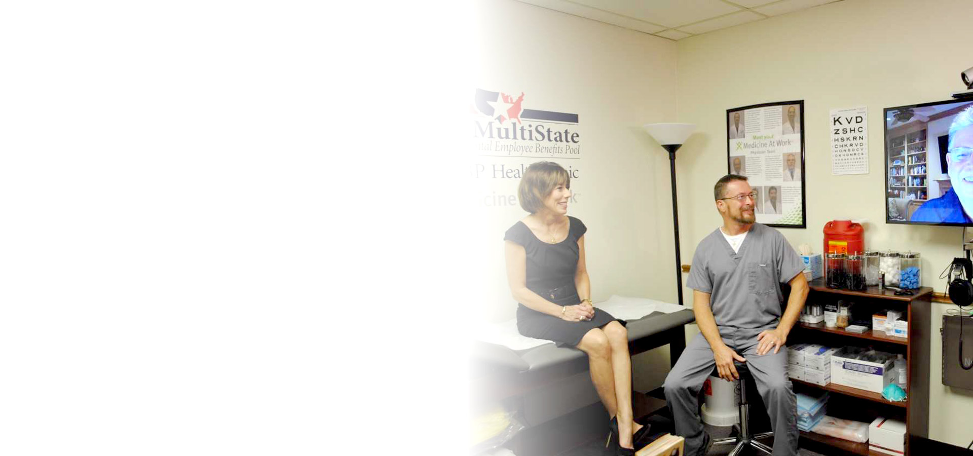 Onsite Medicine At Work clinic where a medic and patient talk with a physician on a telemedicine screen